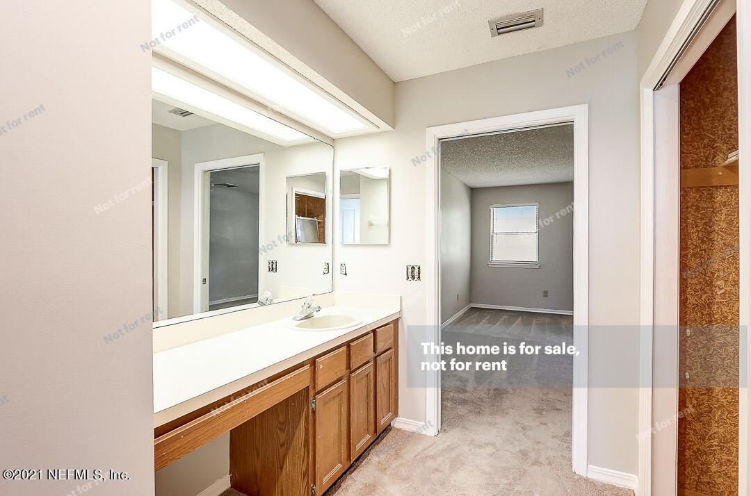 328 North Ridge Drive Orange Park, FL 32003 - Photo 8 of 33 a bathroom with a sink and a mirror