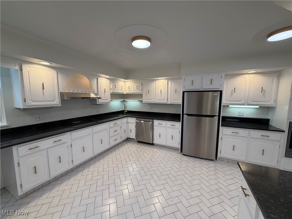 522 North 3rd Street Toronto, OH 43964 - Photo 12 of 47 Kitchen featuring appliances with stainless steel finishes, white cabinetry, dark stone countertops, and under cabinet range hood