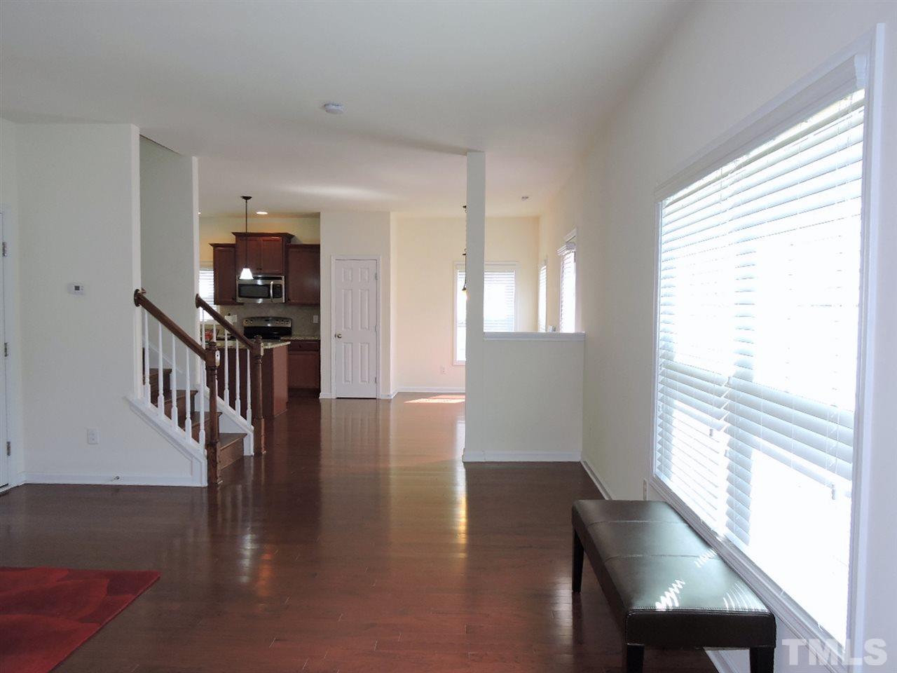 3406 Alman Drive Durham, NC 27705 - Photo 12 of 23 a view of a hallway with wooden floor and staircase