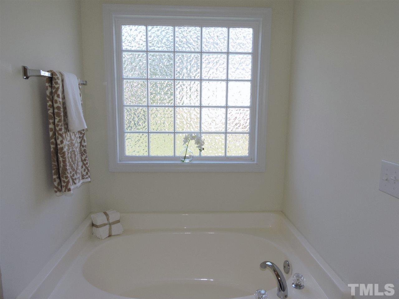 3406 Alman Drive Durham, NC 27705 - Photo 14 of 23 a white bath tub sitting next to a window