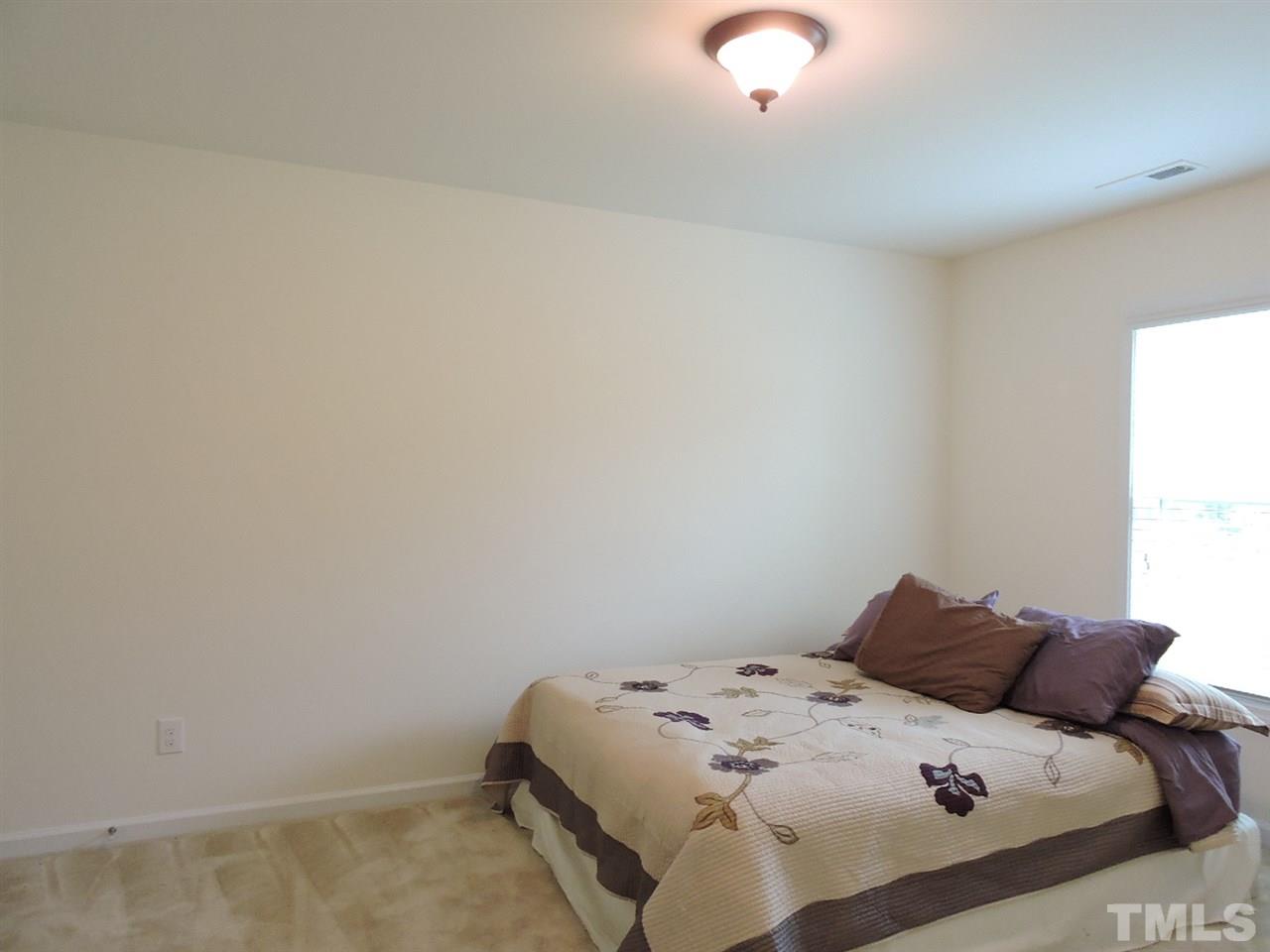3406 Alman Drive Durham, NC 27705 - Photo 17 of 23 a bedroom with a bed and a painting on the wall