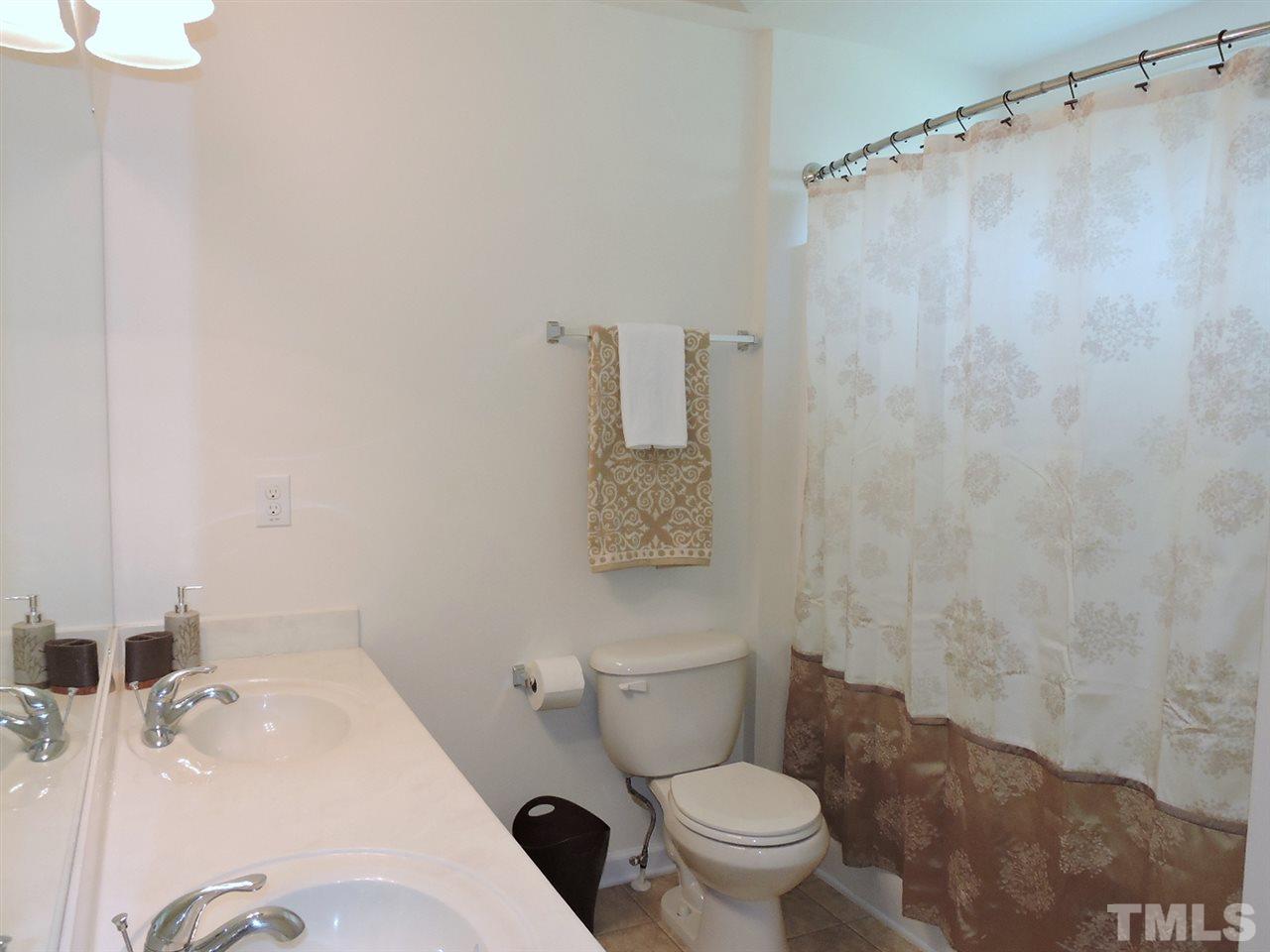 3406 Alman Drive Durham, NC 27705 - Photo 18 of 23 a white toilet sitting next to a bathroom sink