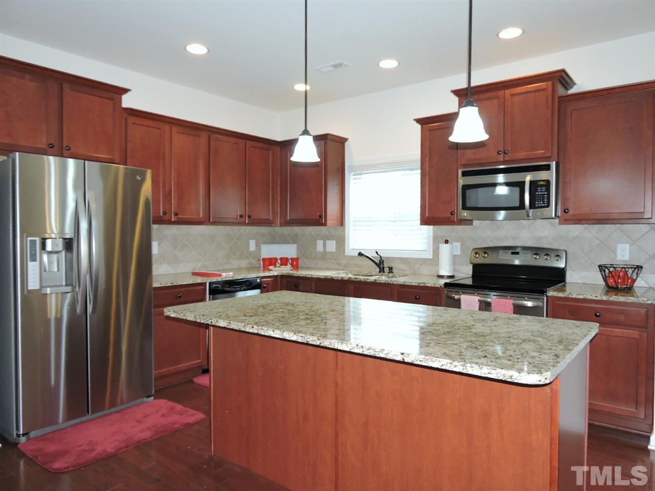 3406 Alman Drive Durham, NC 27705 - Photo 4 of 23 a kitchen with stainless steel appliances granite countertop a sink refrigerator and microwave