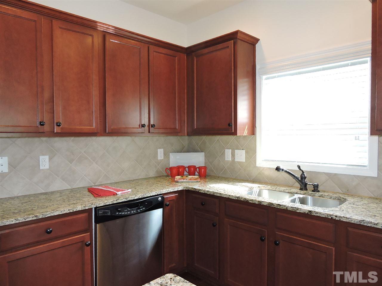 3406 Alman Drive Durham, NC 27705 - Photo 6 of 23 a kitchen with stainless steel appliances granite countertop a sink window and cabinets