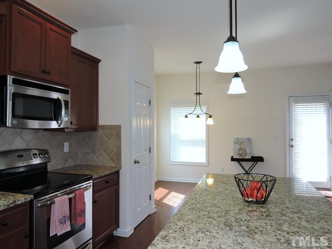 3406 Alman Drive Durham, NC 27705 - Photo 8 of 23 a kitchen with stainless steel appliances granite countertop a stove a sink and a microwave