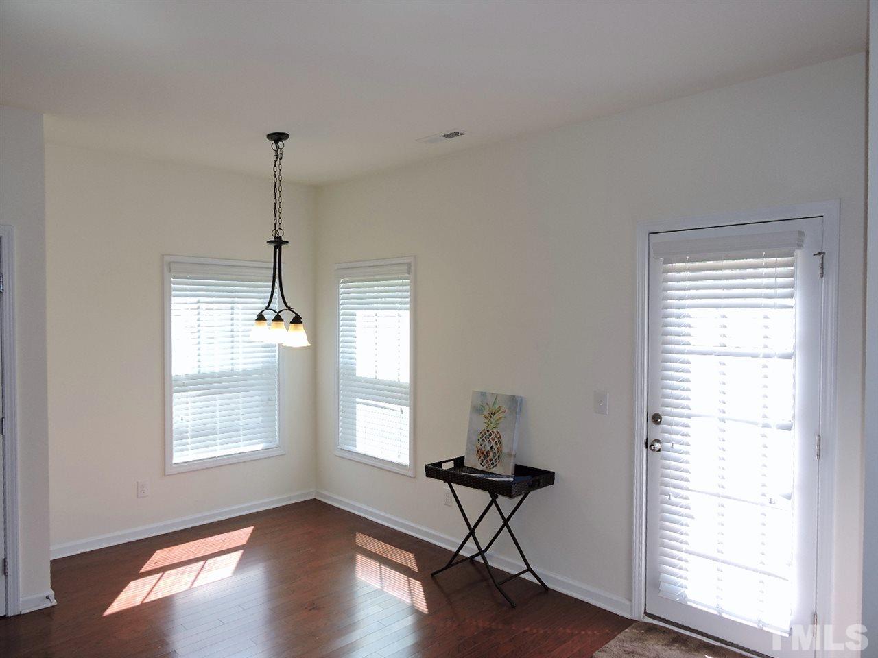 3406 Alman Drive Durham, NC 27705 - Photo 9 of 23 a view of an empty room with a window and wooden floor