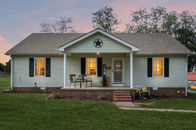a front view of house with yard and outdoor seating