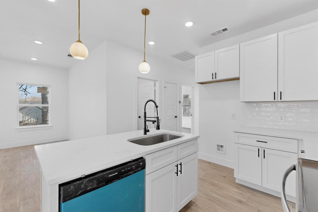 616 East Shepherd Street Denison, TX 75021 - Photo 13 of 23 a kitchen with cabinets and wooden floor