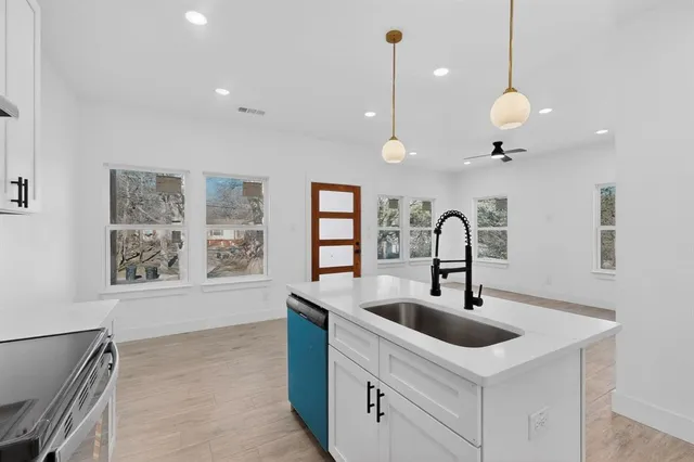 a kitchen with a sink and chandelier
