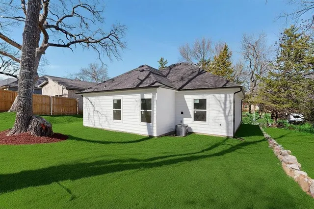 a front view of a house with a garden and yard
