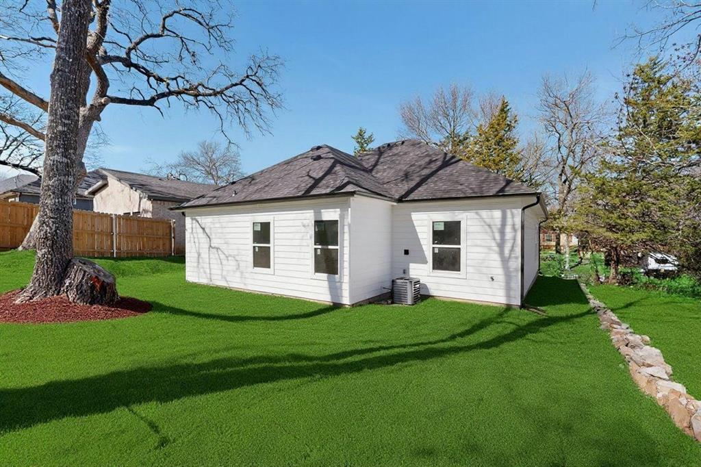 616 East Shepherd Street Denison, TX 75021 - Photo 21 of 23 a front view of a house with a garden and yard