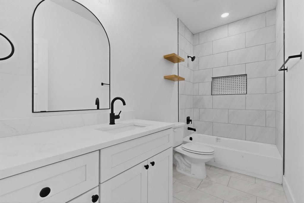 616 East Shepherd Street Denison, TX 75021 - Photo 3 of 23 a bathroom with a sink a toilet and shower