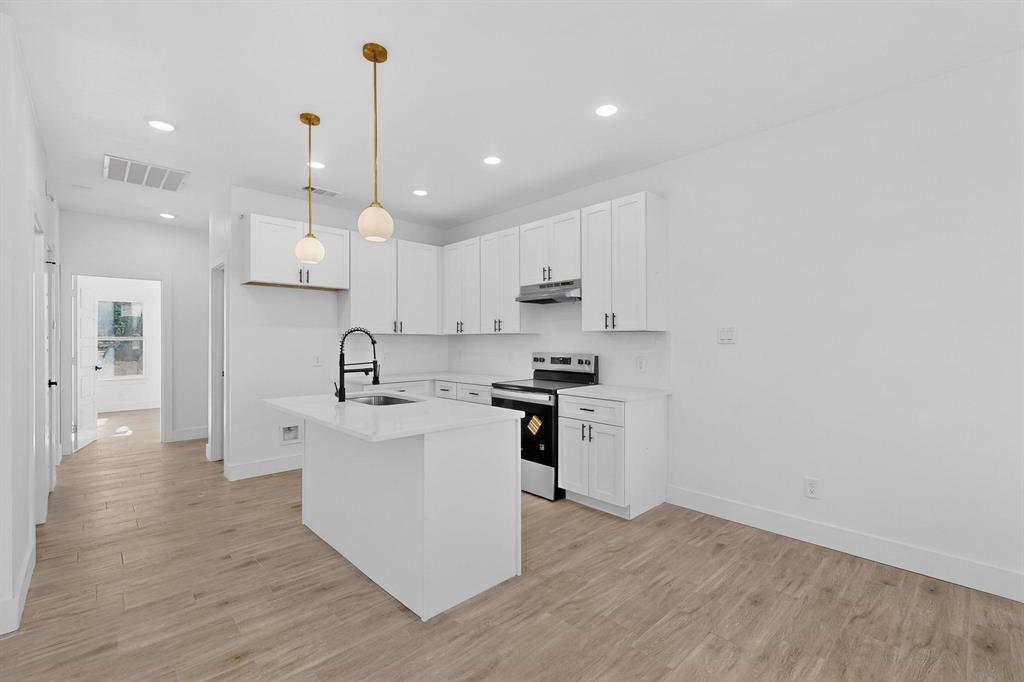 616 East Shepherd Street Denison, TX 75021 - Photo 4 of 23 a kitchen with white cabinets and white appliances