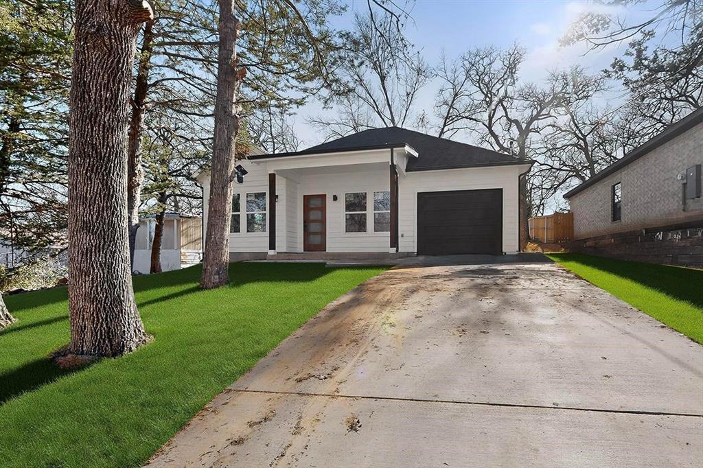 616 East Shepherd Street Denison, TX 75021 - Photo 10 of 23 a front view of a house with a garden and trees