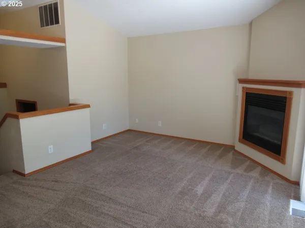 a view of an empty room with a fireplace