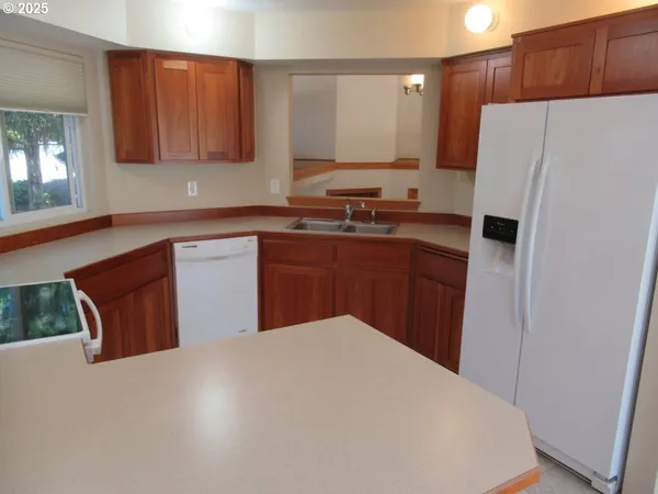 a kitchen with stainless steel appliances a refrigerator and a sink