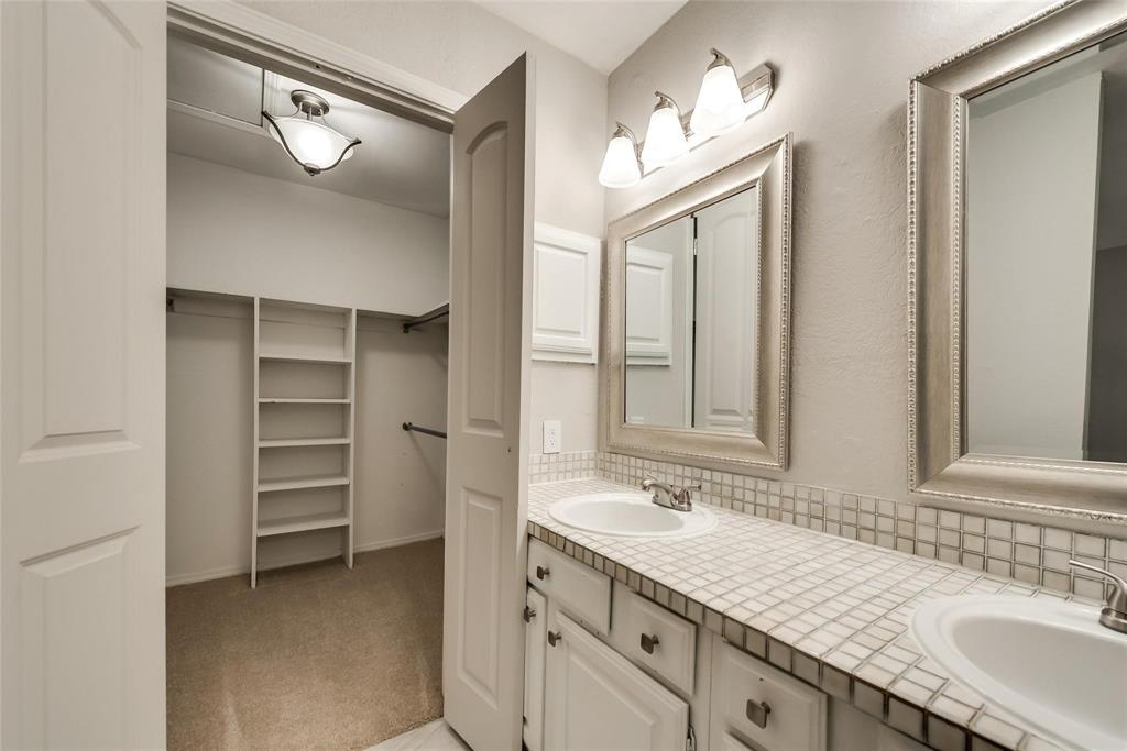 18240 Midway Road, Unit 302 Dallas, TX 75287 - Photo 23 of 33 a bathroom with a granite countertop sink mirror and a