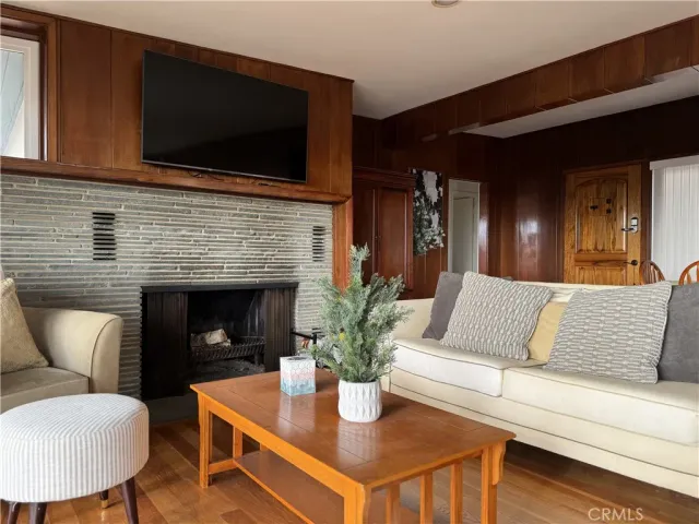 a living room with furniture fireplace and flat screen tv