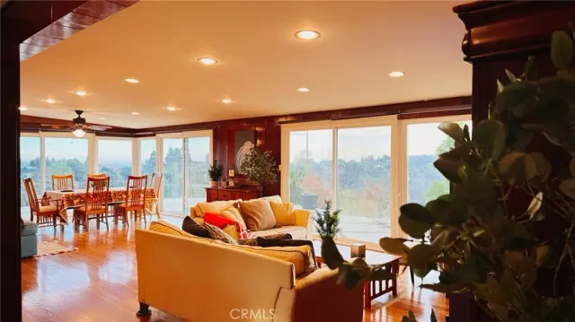 a living room with lots of furniture and a floor to ceiling window