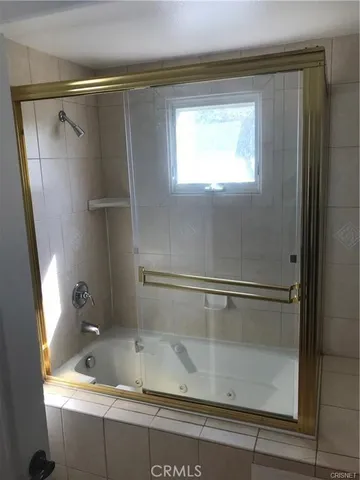 a bathroom with a bathtub and a shower