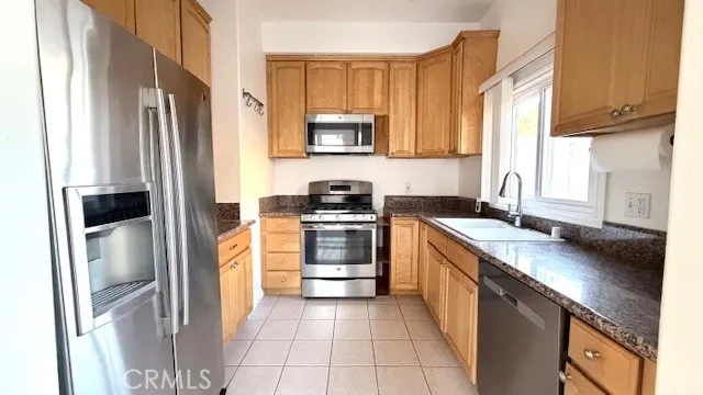 a kitchen with a sink stove and refrigerator
