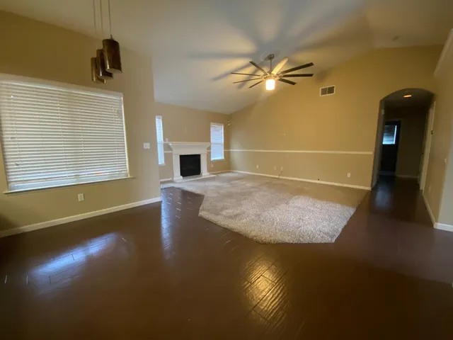 a view of a livingroom with a ceiling fan and window