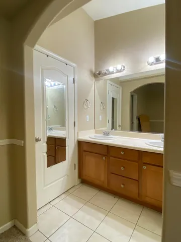 a spacious bathroom with a granite countertop sink mirror and