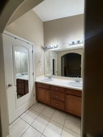 a bathroom with a granite countertop sink mirror and toilet