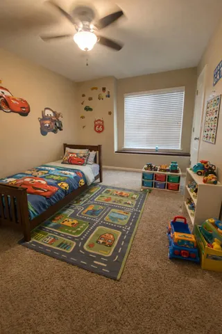 a bedroom with bed and window
