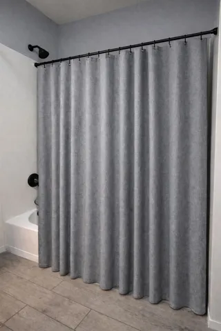 a bathroom with a shower curtain and a sink