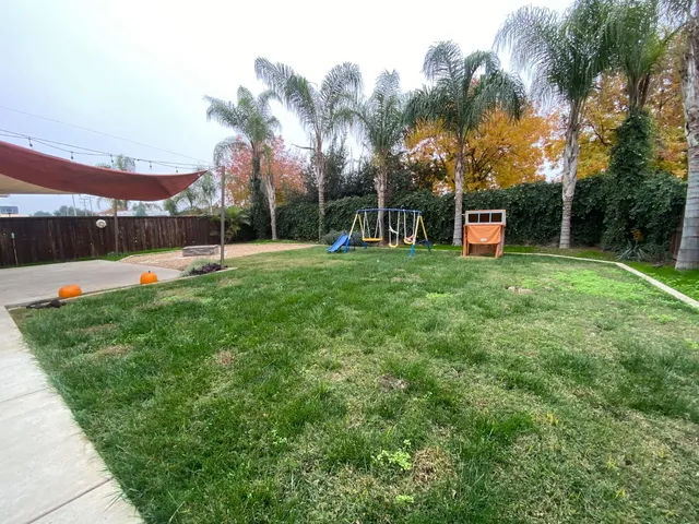 a view of a house with a yard and sitting area