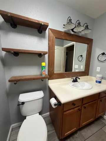 a bathroom with a toilet sink and mirror