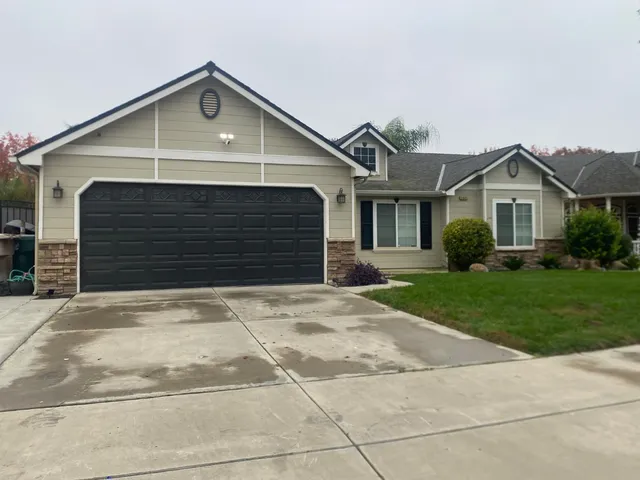 a front view of a house with a yard and garage