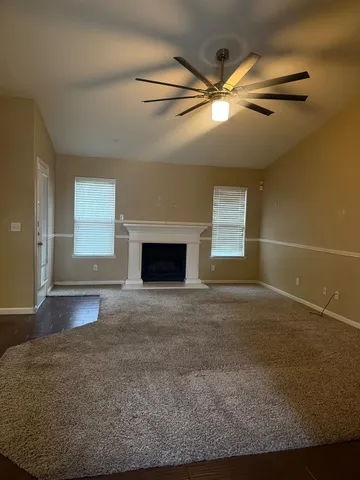a view of empty room with window and fireplace