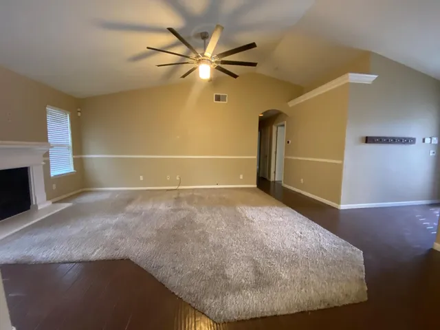a view of a livingroom with a ceiling fan and window