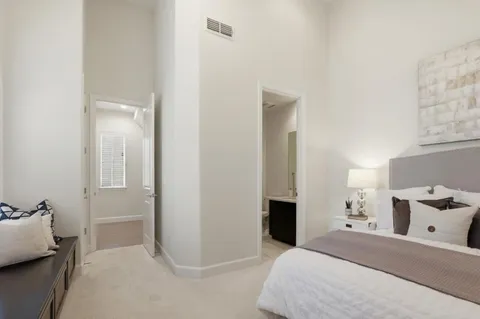 a bedroom with a bed and a painting on the wall