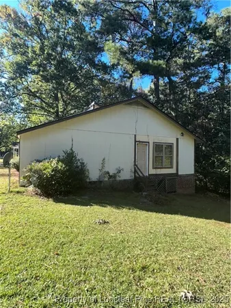 a view of a house with a large tree