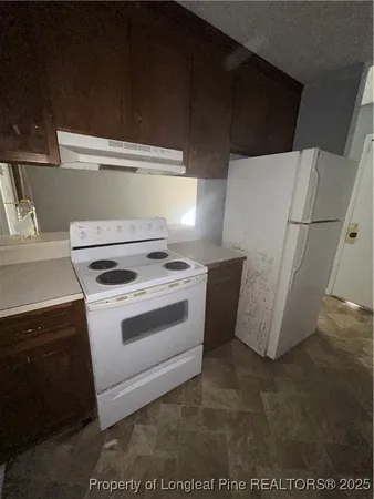 a white refrigerator freezer and a dishwasher sitting in a kitchen