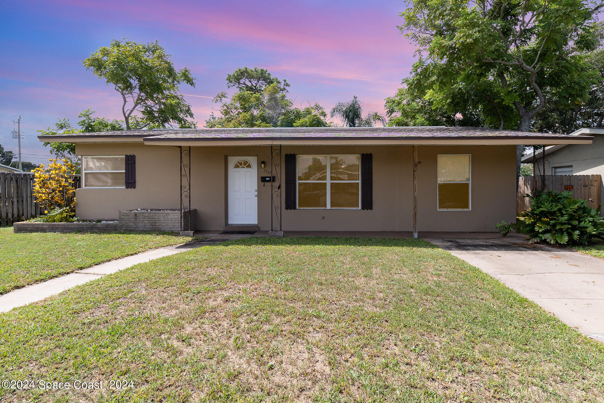 2357 Sarno Road Melbourne, FL 32935 - Photo 1 of 19 front view of a house with a yard