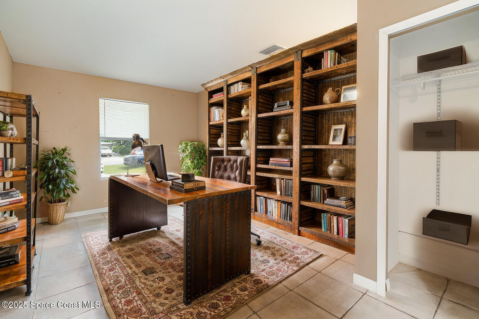 2357 Sarno Road Melbourne, FL 32935 - Photo 12 of 19 a living room with furniture and a book shelf