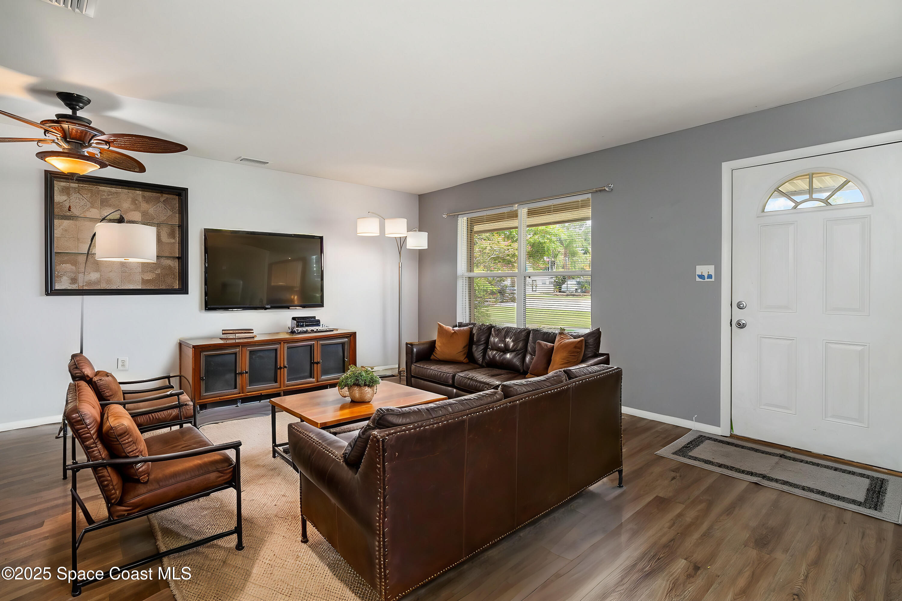 2357 Sarno Road Melbourne, FL 32935 - Photo 2 of 19 a living room with furniture and a flat screen tv