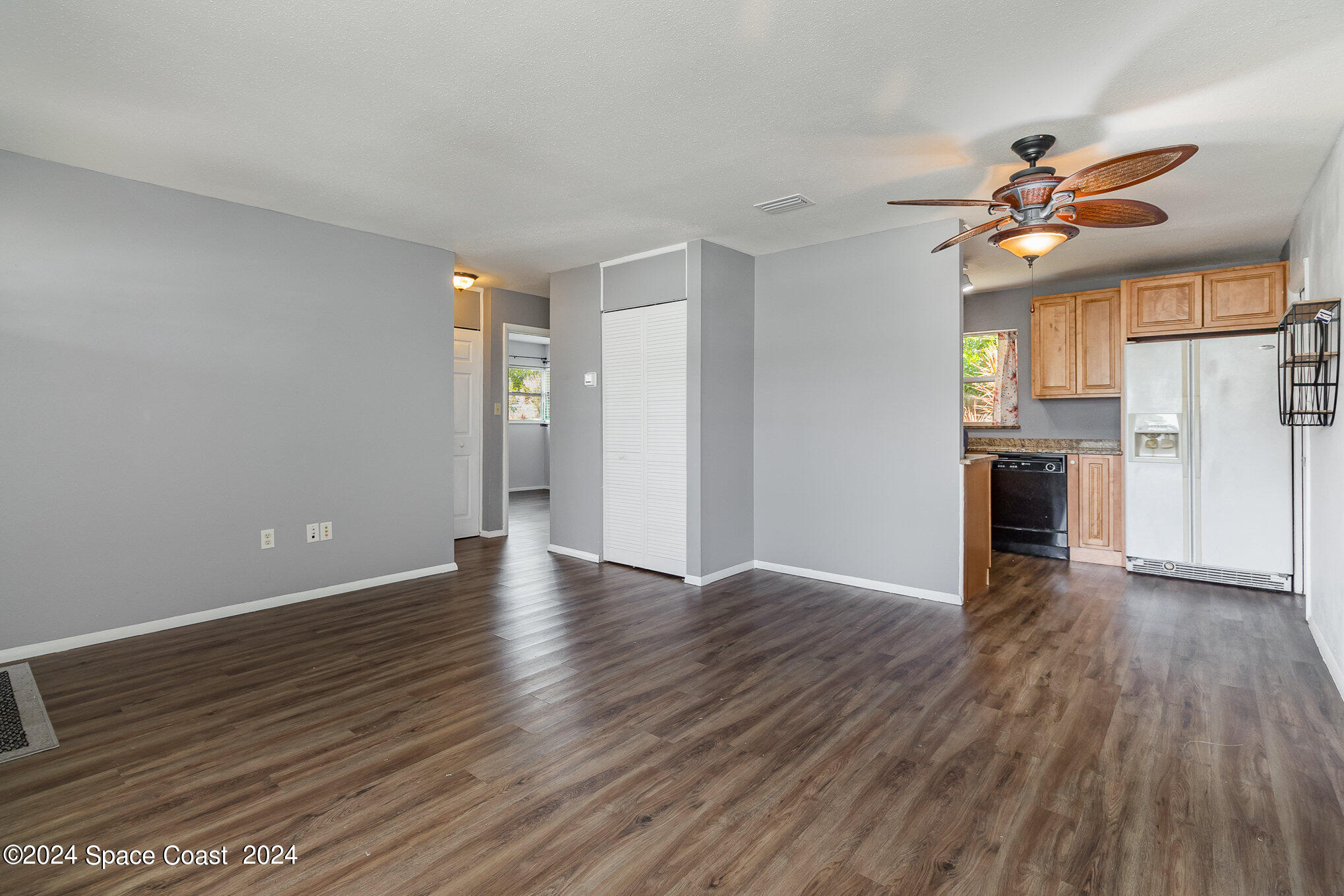 2357 Sarno Road Melbourne, FL 32935 - Photo 5 of 19 a view of a livingroom with wooden floor and a ceiling fan
