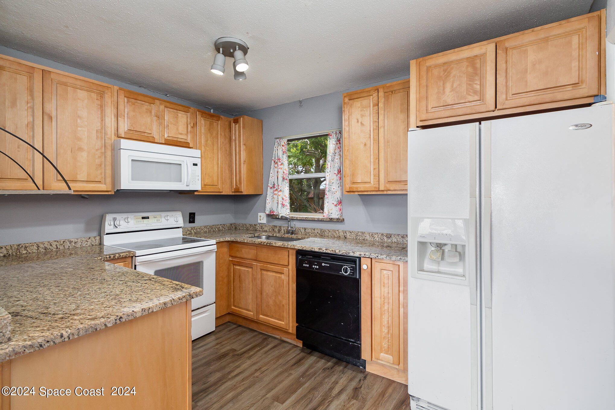 2357 Sarno Road Melbourne, FL 32935 - Photo 6 of 19 a kitchen with stainless steel appliances granite countertop a stove a sink and a refrigerator