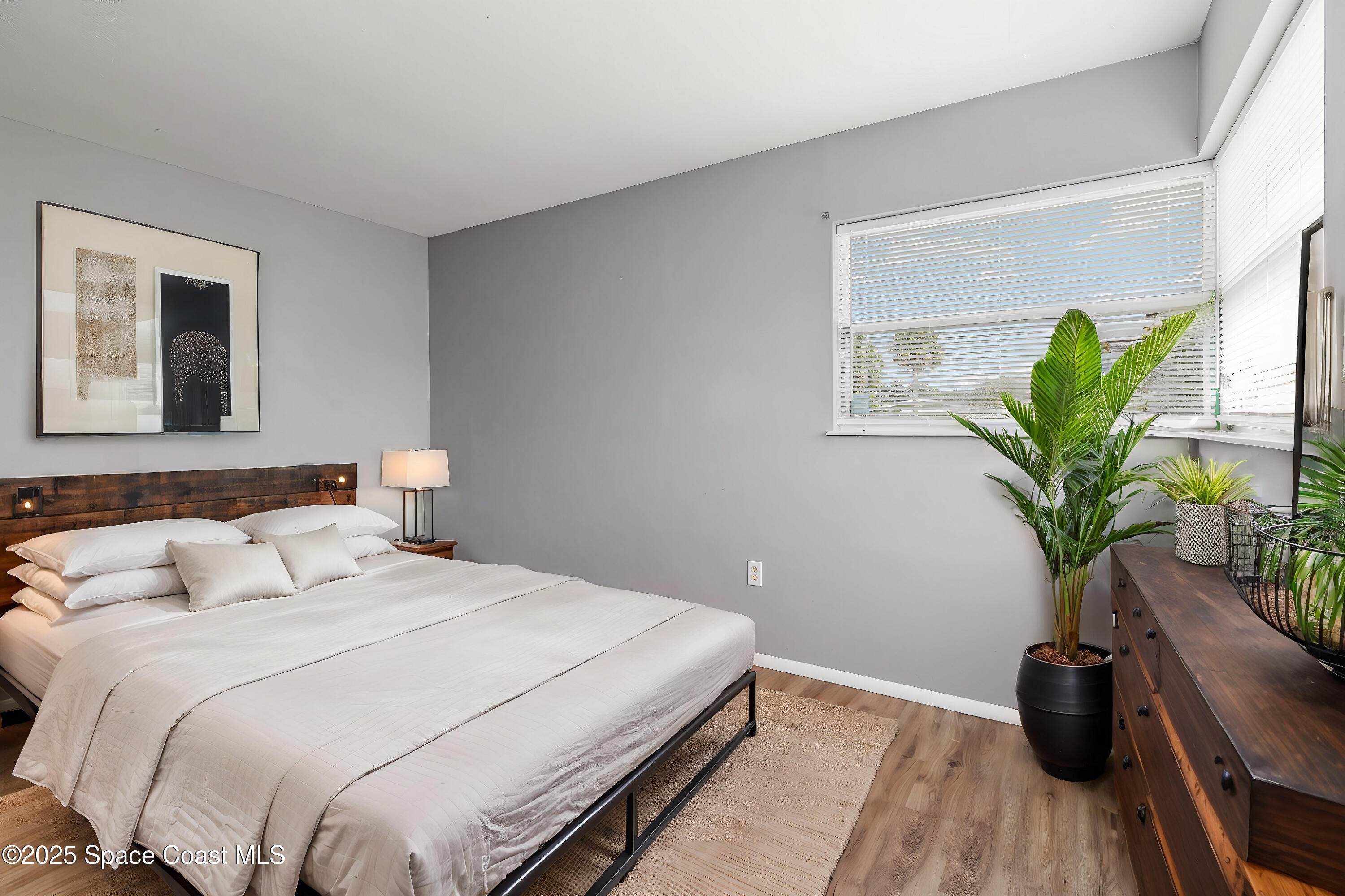 2357 Sarno Road Melbourne, FL 32935 - Photo 7 of 19 a bedroom with bed and a potted plant
