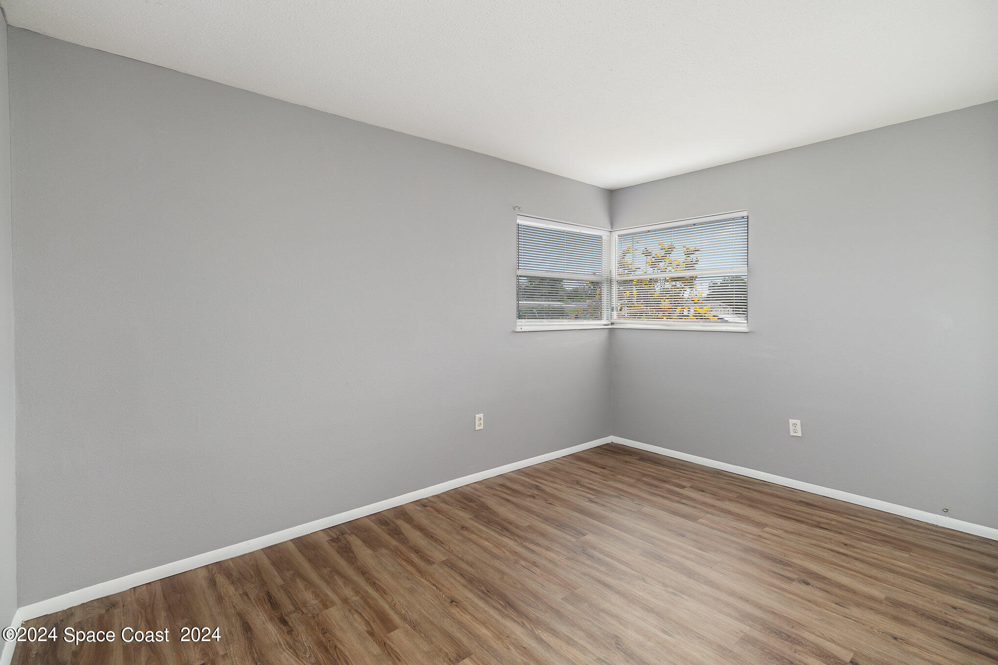 2357 Sarno Road Melbourne, FL 32935 - Photo 8 of 19 a view of an empty room with wooden floor and a window