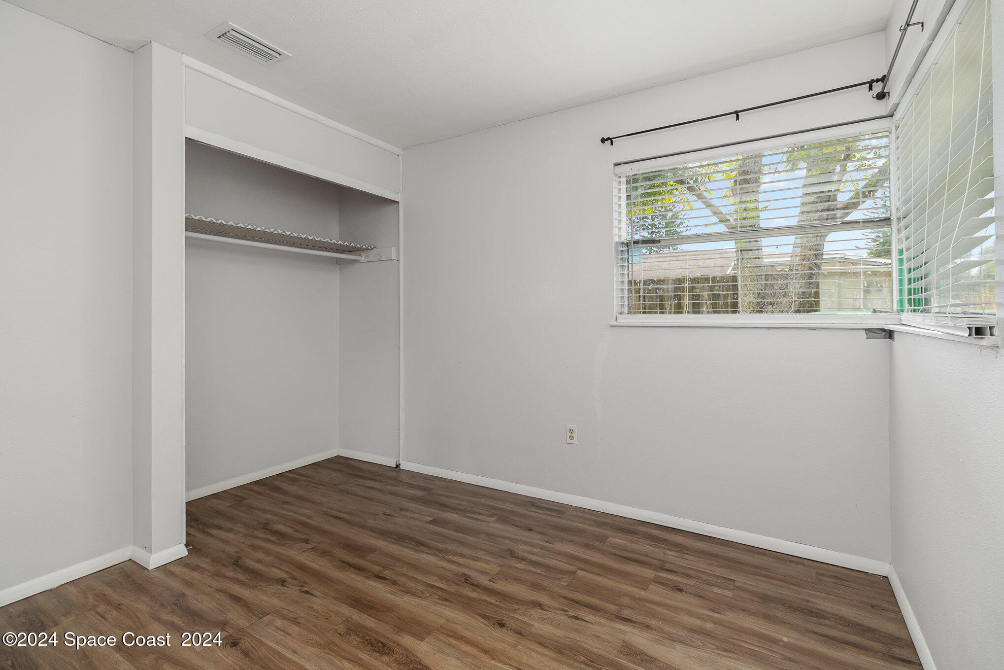 2357 Sarno Road Melbourne, FL 32935 - Photo 10 of 19 a view of empty room with wooden floor and fan
