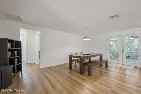 a dining room with furniture and wooden floor