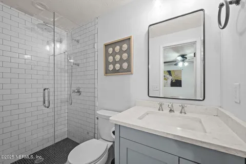a bathroom with a sink toilet and shower