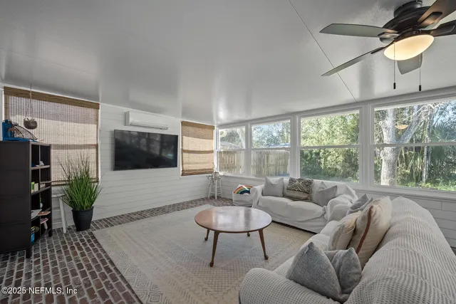 a living room with furniture and a flat screen tv
