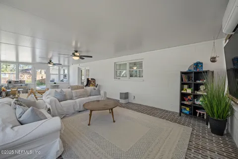 a living room with furniture and a potted plant